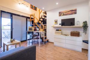 a living room with a couch and a table and a staircase at Way to Coast in Sant'Egidio del Monte Albino