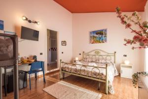 a bedroom with a bed and a desk and a television at Way to Coast in Sant'Egidio del Monte Albino