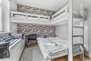 a bedroom with two bunk beds and a desk at Walter&Sons Apartment Centro in Poděbrady