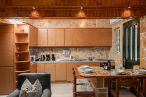 a kitchen with a table and a dining room at Zeusplace Crown Platamon in Platamonas