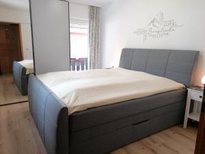 a bedroom with a large bed in a room at Haus Bischoff 2 in Halblech