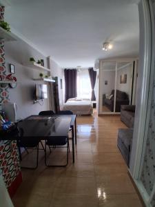 a living room with a table and a couch at Studio Benal Iris in Málaga