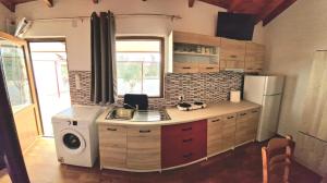 a kitchen with a sink and a refrigerator at Dream in Kamáres