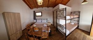 a room with a table and two bunk beds at Dream in Kamáres