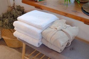 a pile of towels sitting on a wooden rack at Tôlluste Villa in Tõlluste