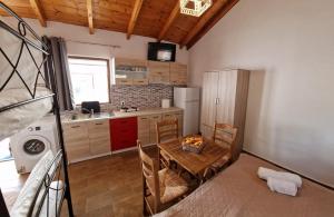 a small kitchen with a table and a refrigerator at Dream in Kamáres