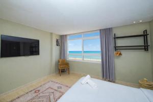 a hotel room with a bed and a large window at Singular Hotel, SH Dakhla in Dakhla