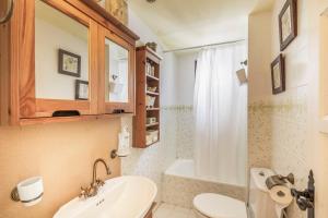 a bathroom with a sink and a toilet and a tub at Ducado B104 in Pals +24 photos