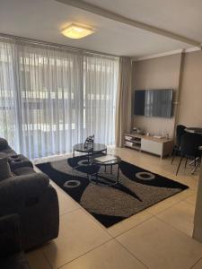 a living room with a couch and a table at 1 Bedroom Marina Bay Apartment 7 in Durban