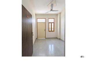 an empty room with a door and a hallway at Hotel HMI International in Meerut