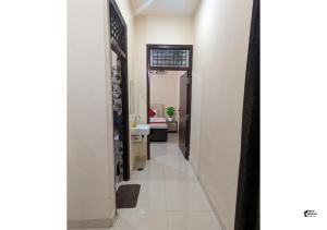 a hallway leading to a room with a bathroom at Hotel HMI International in Meerut