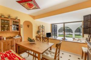 a kitchen and dining room with a wooden table at Ducado B104 in Pals