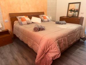 a bedroom with a large bed with two pillows at Galliu'S home in Selargius