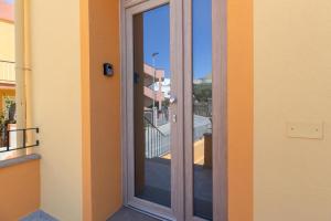 a sliding glass door on a building with a balcony at La Pulvarera in Castelsardo +52 photos