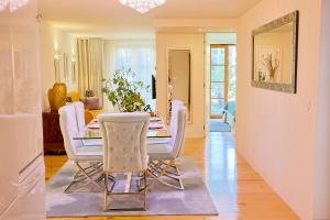 a dining room and living room with a table and chairs at TM Luxury Apartments Lisbon in Lisbon