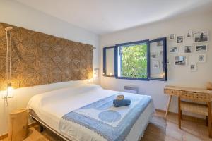 a bedroom with a bed and a window and a table at Bosc in Pals +28 photos