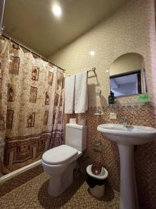 a bathroom with a toilet and a sink at Shuxrat hotel in Chilanzar