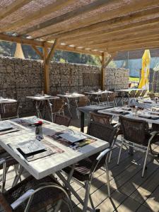 a group of tables and chairs on a patio at L'Abribis in Firminy