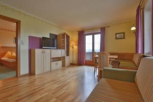 a living room with a couch and a dining room at Stiedlbauerhof in Seeham