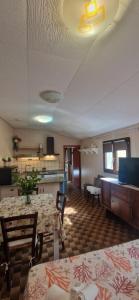 a living room with a table and chairs and a couch at Tertium Home in Telti
