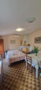a bedroom with a bed and a table and a chair at Tertium Home in Telti