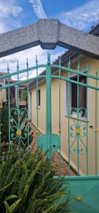 a green fence in front of a house at Tertium Home in Telti