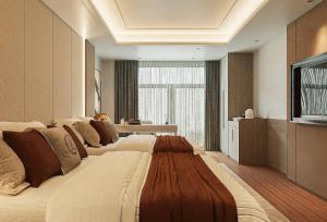 a large bed in a room with a television at Splendid Star Suite Hotel in Hanoi