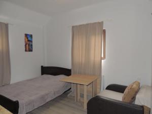 a bedroom with a bed and a table and a chair at Agmashenebeli house 3 in Mtskheta