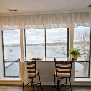 a dining room with a large window with a table and chairs at Tranquil Retreat - Close to everything you need in Osage Beach