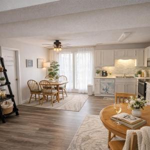 a kitchen and living room with a table and chairs at Tranquil Retreat - Close to everything you need in Osage Beach