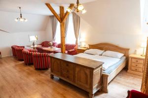a bedroom with a bed and some red chairs at Tavba apartment in Česká Lípa