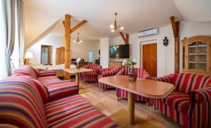 a living room with red striped couches and tables at Tavba apartment in Česká Lípa