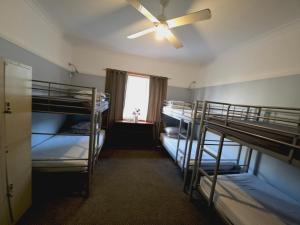a room with three bunk beds and a window at Coogee Beach House in Sydney