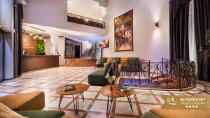 a living room with couches and tables at Alfaresort Palace Chiflika in Chiflik