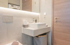 a bathroom with a sink and a washing machine at White Haven in Korinthos +14 photos