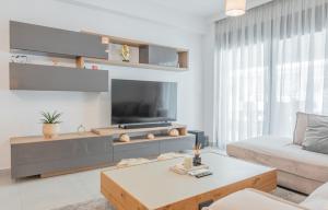 a living room with a tv and a couch at White Haven in Korinthos