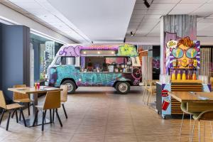 a food truck parked in a restaurant with tables and chairs at nhow Brussels Bloom in Brussels