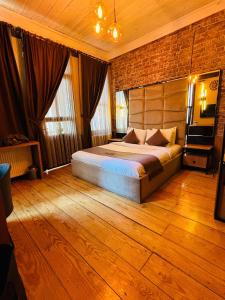 a bedroom with a bed and a brick wall at Berfinn Hotel Beşiktaş in Istanbul