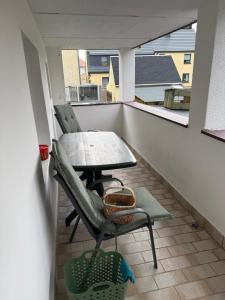 a table and chairs on a balcony with a table at Ferienwohnung Waidmannsheil in Amtsberg
