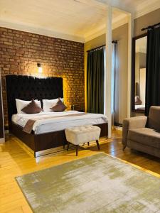 a bedroom with a large bed and a brick wall at Berfinn Hotel Beşiktaş in Istanbul +7 photos