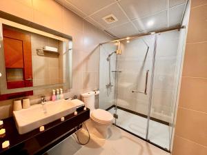 a bathroom with a shower and a toilet and a sink at Gllant Villa Hà Nội in Hanoi +57 photos