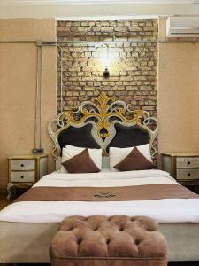 a bedroom with a large bed with a brick wall at Berfinn Hotel Beşiktaş in Istanbul
