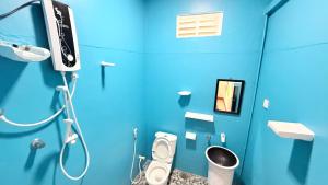 a blue bathroom with a shower and a toilet at Hotel Angel Inn Beach in Trincomalee +157 photos