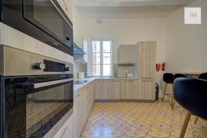 a kitchen with wooden cabinets and a stove top oven at Private Room in Hamrun HMR006 in Hamrun