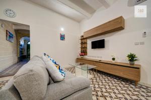 a living room with a couch and a tv at Private Room in Hamrun HMR006 in Hamrun