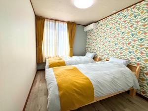 a bedroom with two beds and a window at 凪 nagi Awaji in Awaji