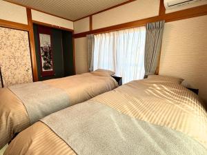 two beds in a room with a window at 凪 nagi Awaji in Awaji +22 photos