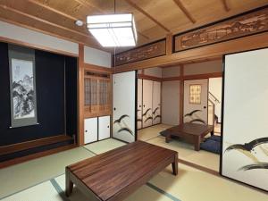 a room with a table and a bench in it at 凪 nagi Awaji in Awaji
