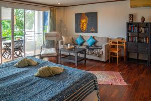a living room with two beds and a couch at Southern Lanta Apartments in Ko Lanta +170 photos