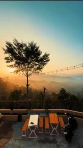 a table and chairs with a view of the mountains at TheLocals HomeStay in Dhulikhel